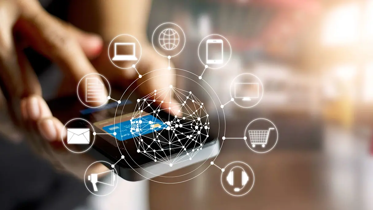 A person holding a phone with digital illustration of shopping icons