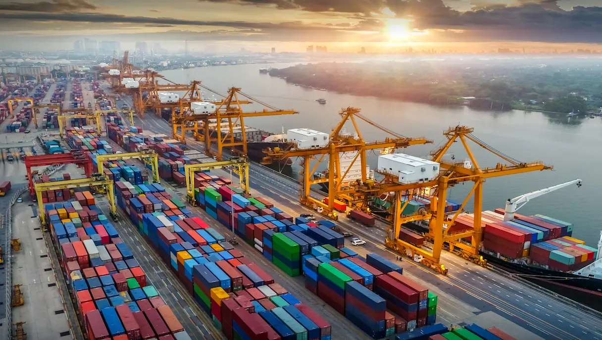 Container port with cargo ships at sunrise view