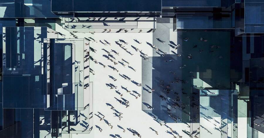 Ariel view of people surrounded by buildings.