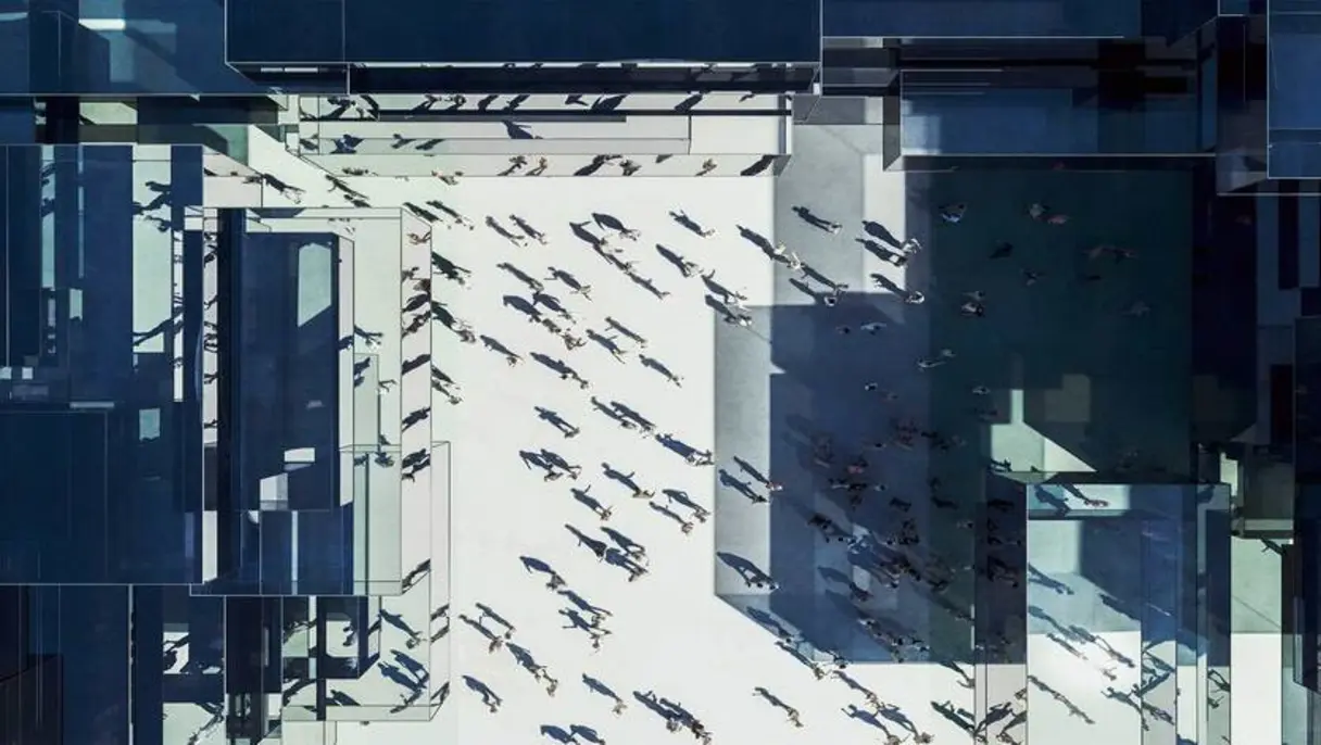 Ariel view of people surrounded by buildings.