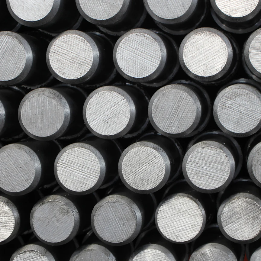 Close-up view of stacked steel rods with a polished surface, showcasing their uniform cylindrical shape and texture.