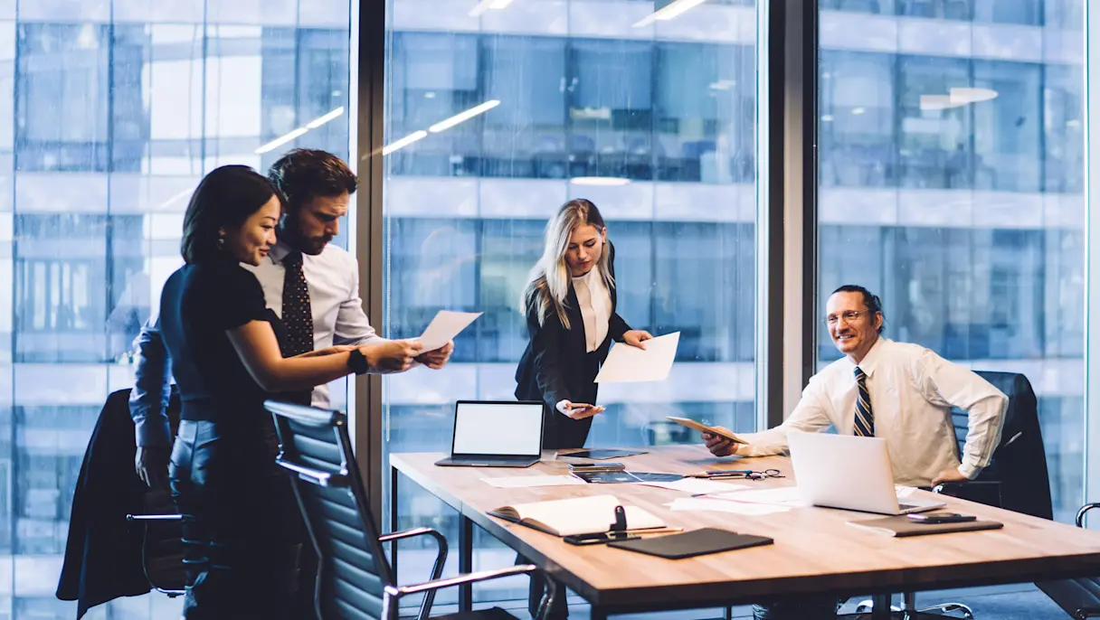 Business team reviewing documents in meeting room