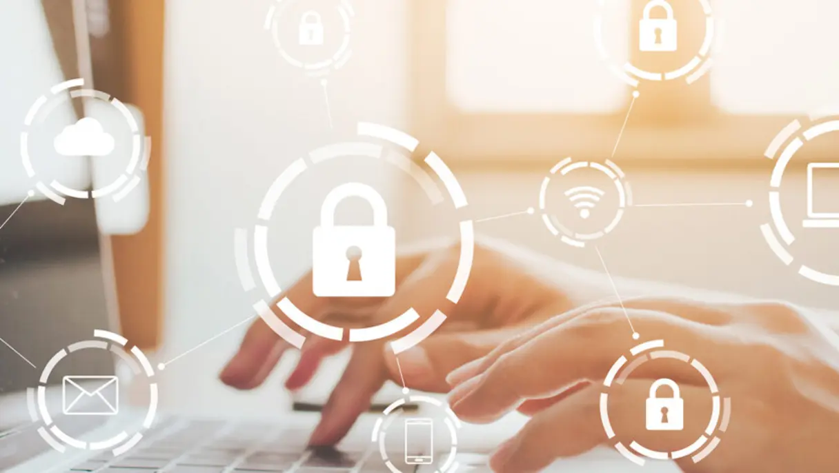 Hands typing on a laptop keyboard with digital security icons overlayed, including padlocks, cloud, email, and Wi-Fi symbols.