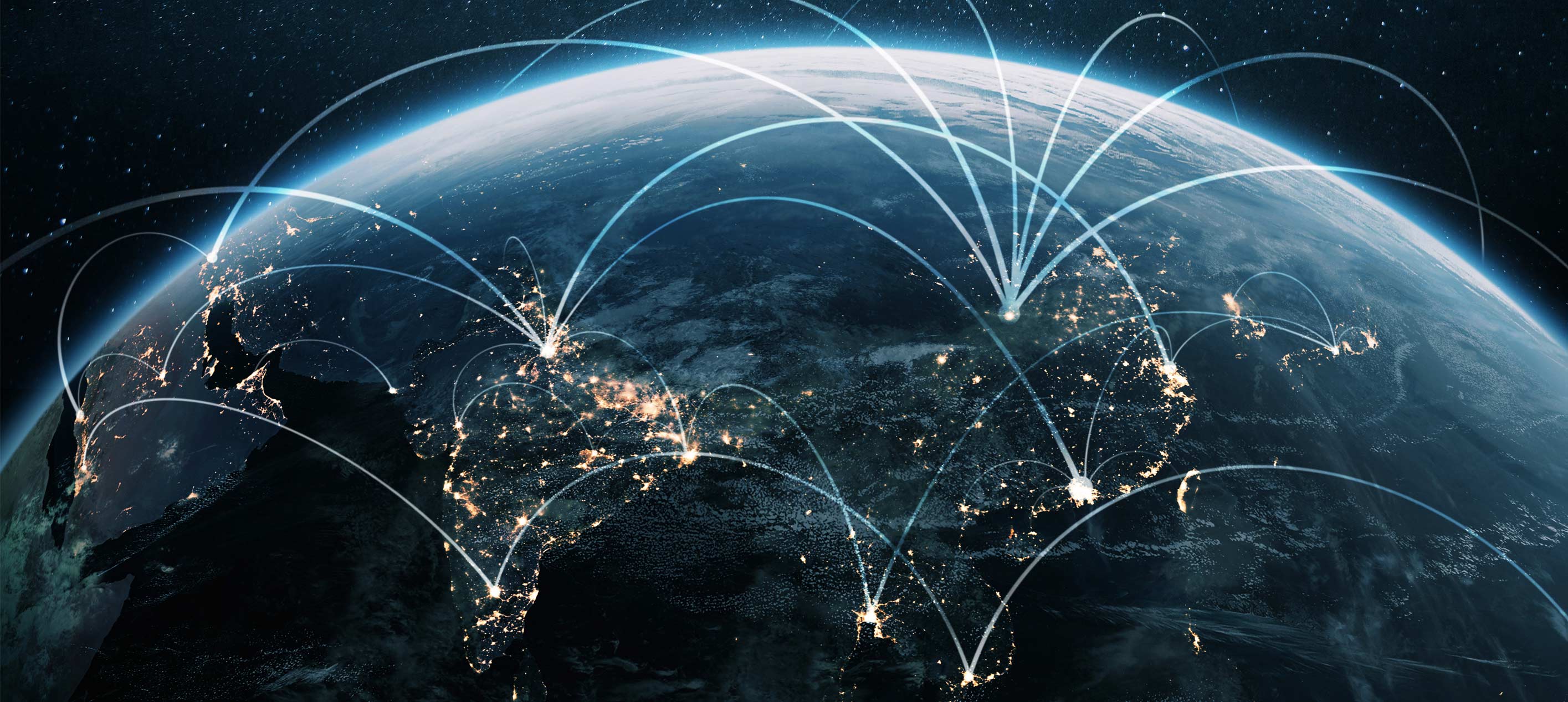 Satellite view of Earth at night over Asia-Pacific with illuminated cities and curved connection lines across the region.