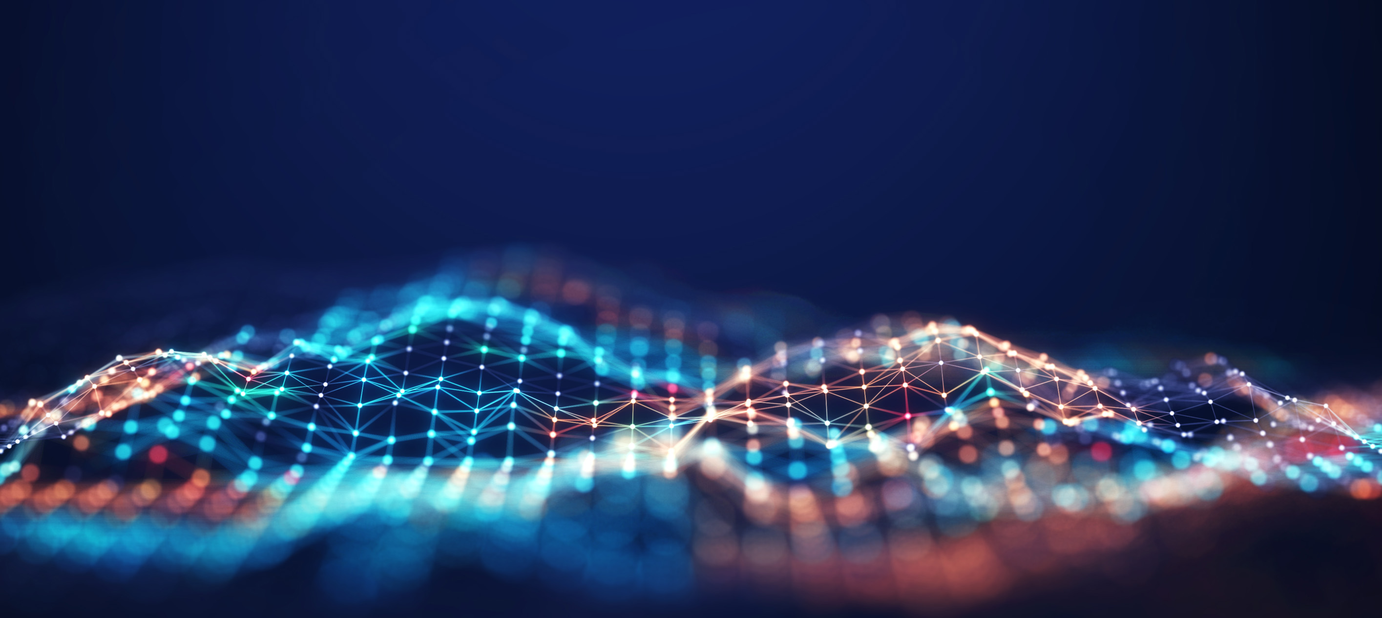 Abstract digital landscape of glowing blue and orange interconnected nodes forming wave-like patterns against a dark blue background.