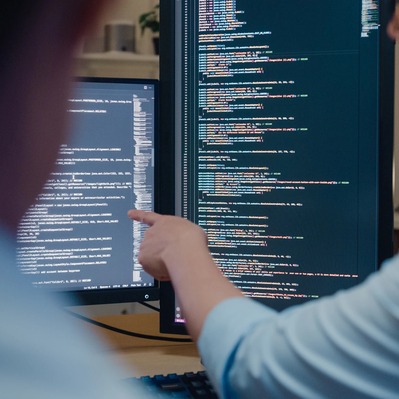 Person Pointing at Computer Screen