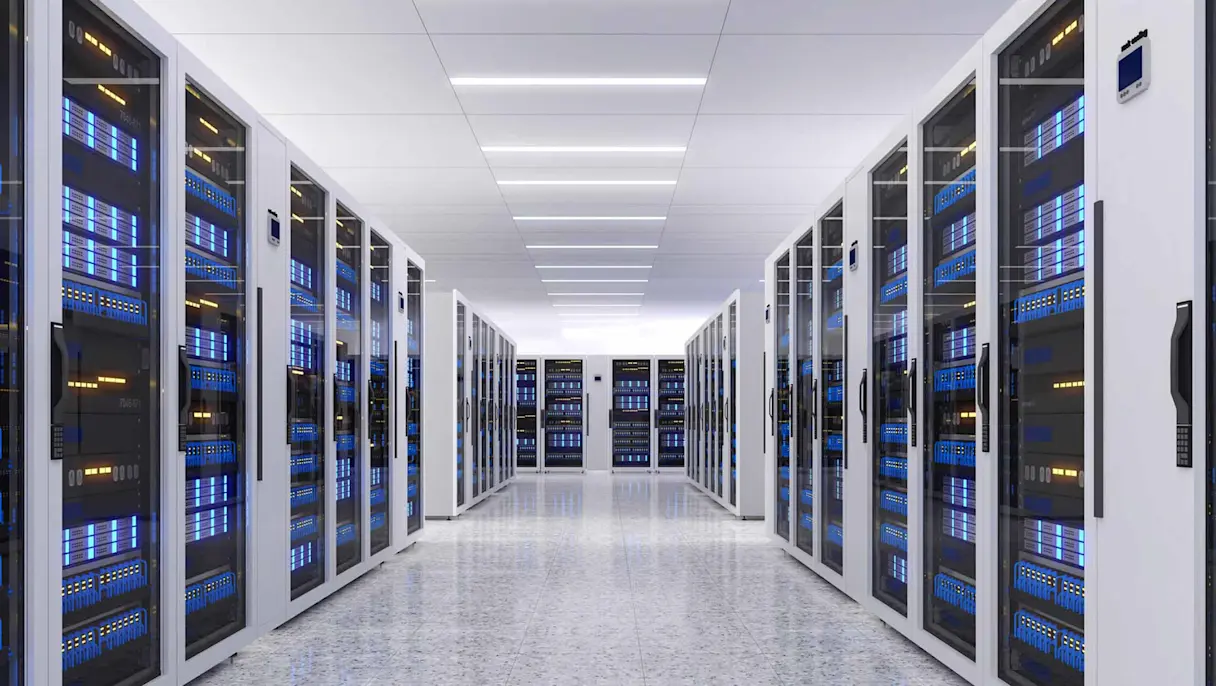 Modern data center with rows of illuminated server racks.