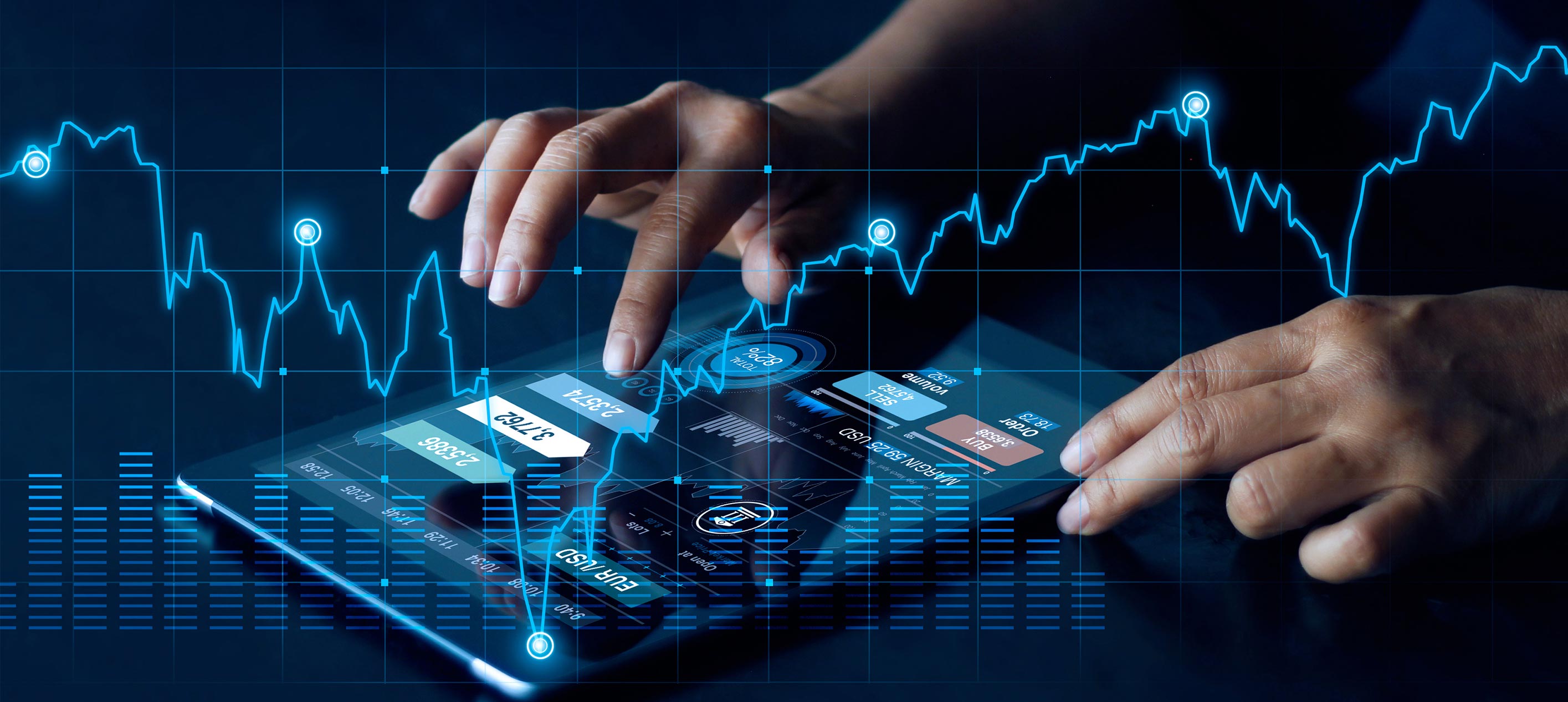 Hands touching a tablet showing trading charts, currency pairs and financial data over a glowing blue line graph.