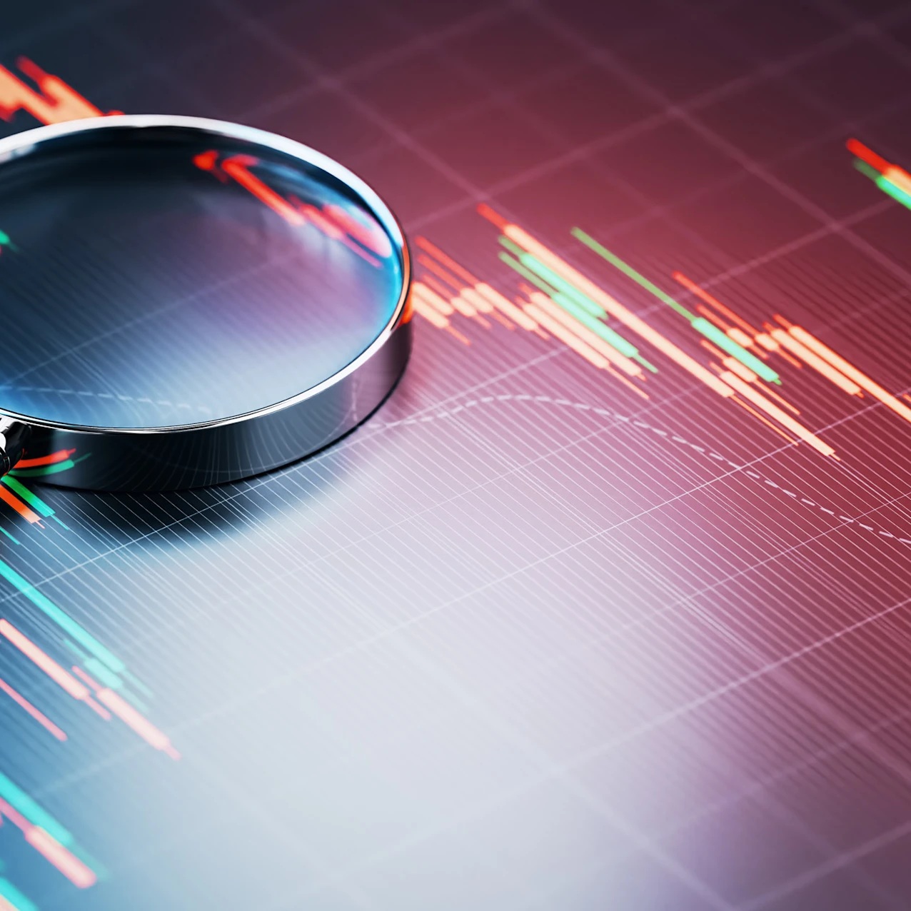 magnifying glass placed over a stock market chart
