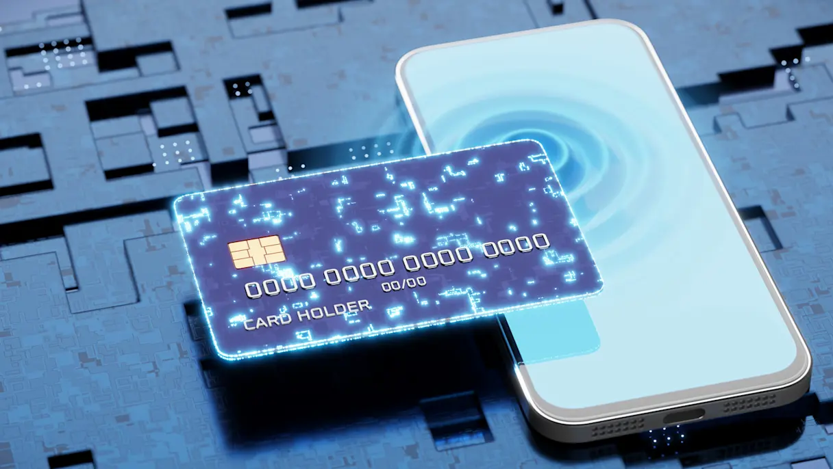 Digital illustration of a glowing credit card overlapping a smartphone on a blue circuit board background, representing digital payments and financial technology.