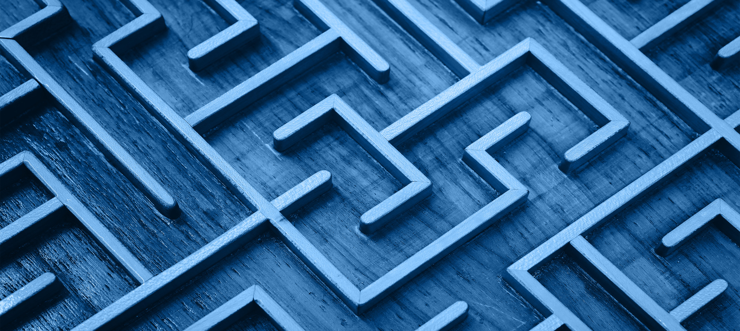  wooden labyrinth maze puzzle tinted in blue, commonly used as a conceptual symbol for problem-solving, strategy, and challenges