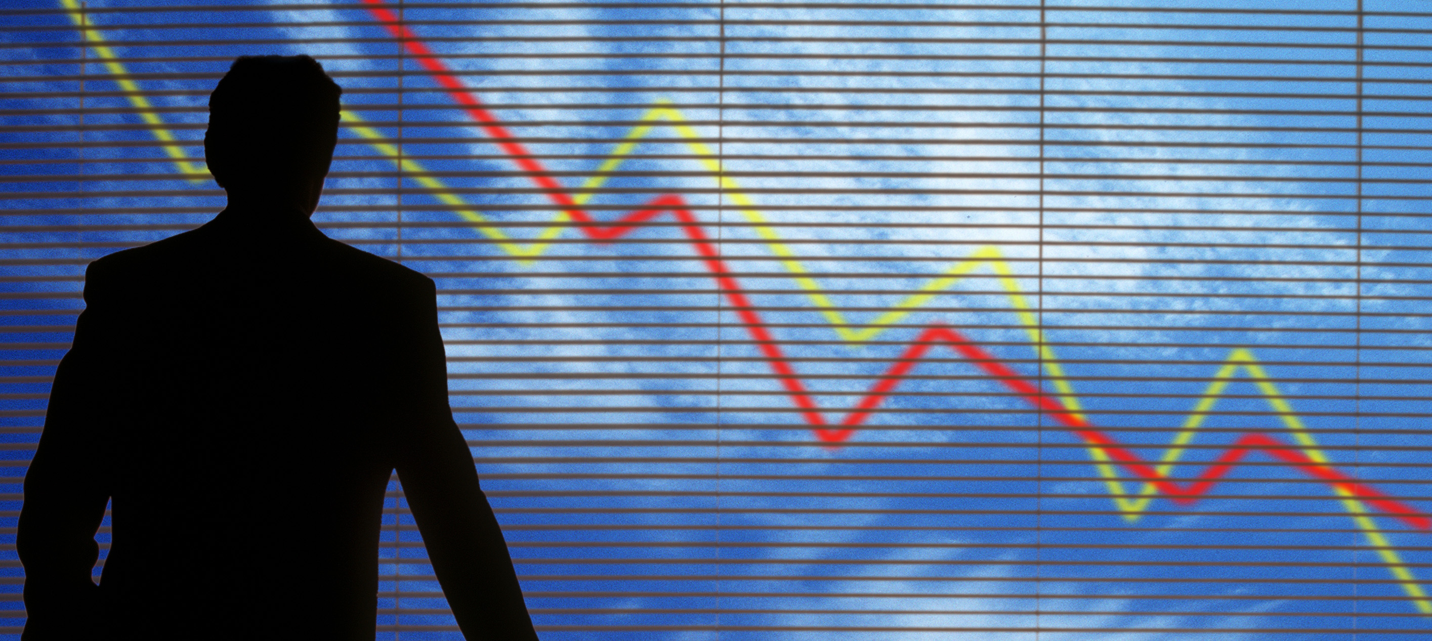 Business silhouette before declining market chart