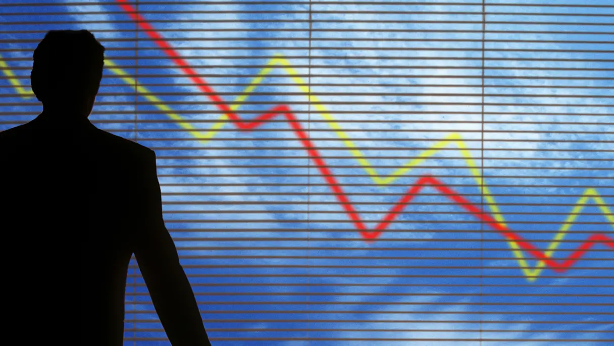 Business silhouette before declining market chart