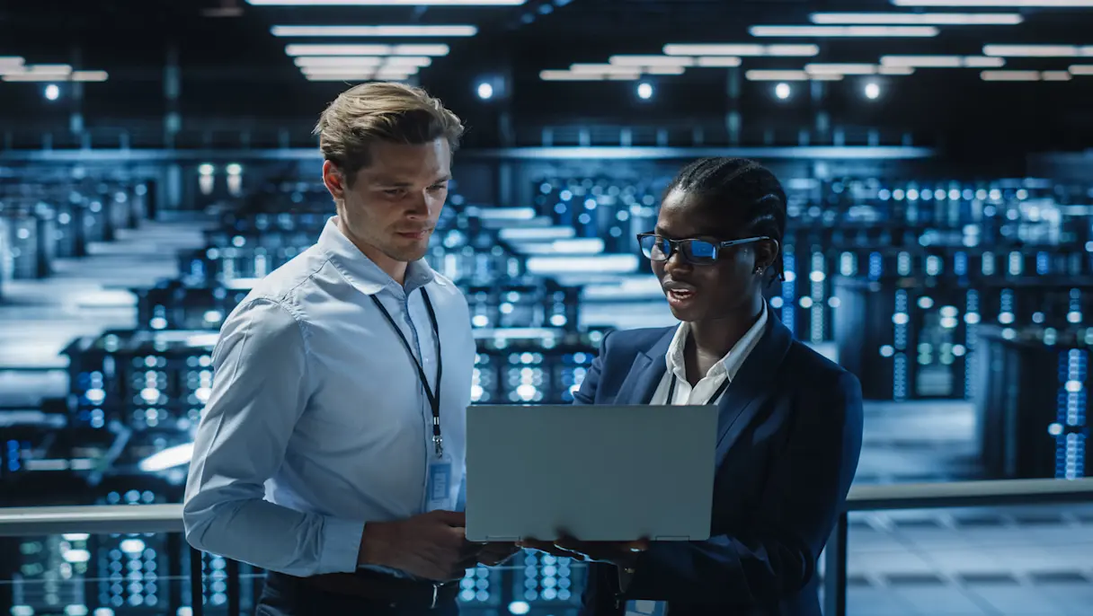 Two professionals in a modern data center