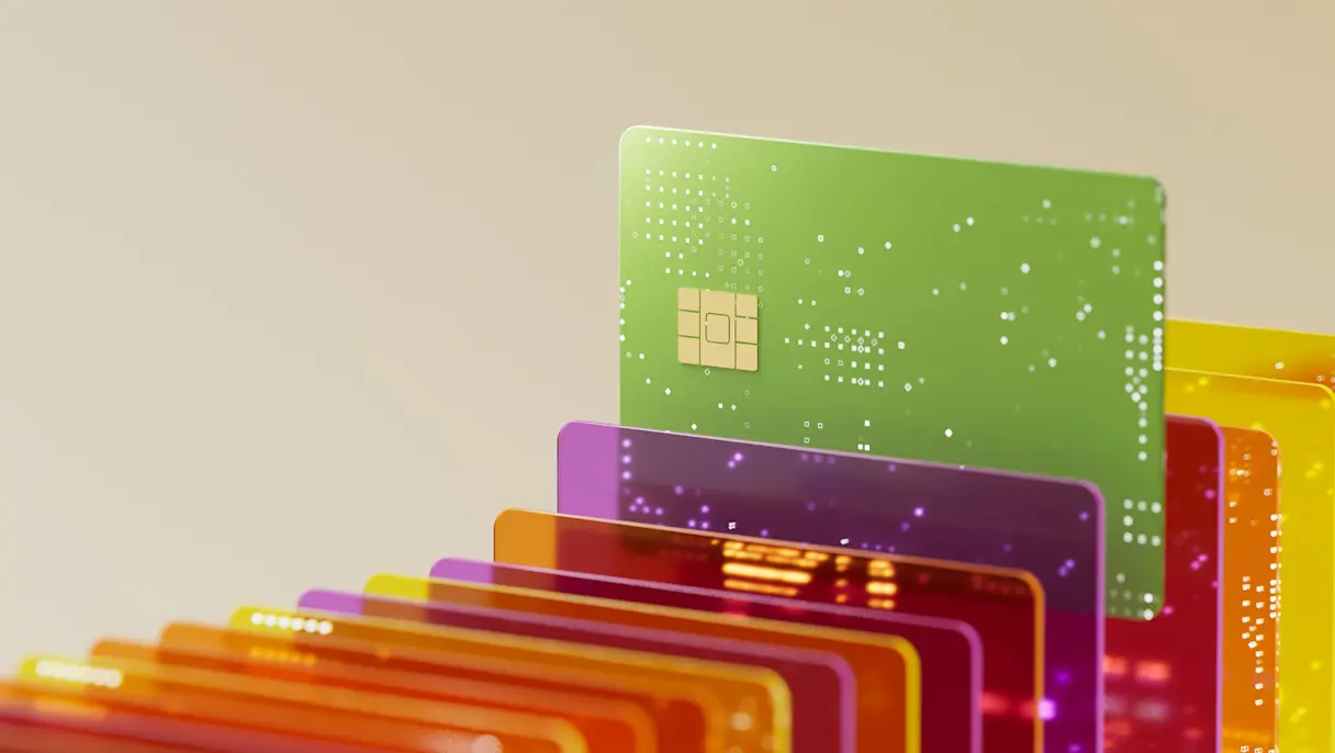 Row of colorful credit cards with a green credit card taller than the rest