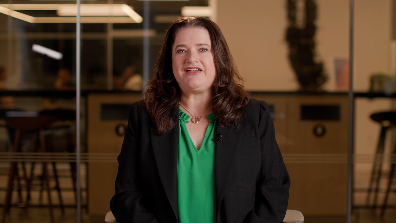 Miriam Wrobel sitting indoors with a blurred office background.