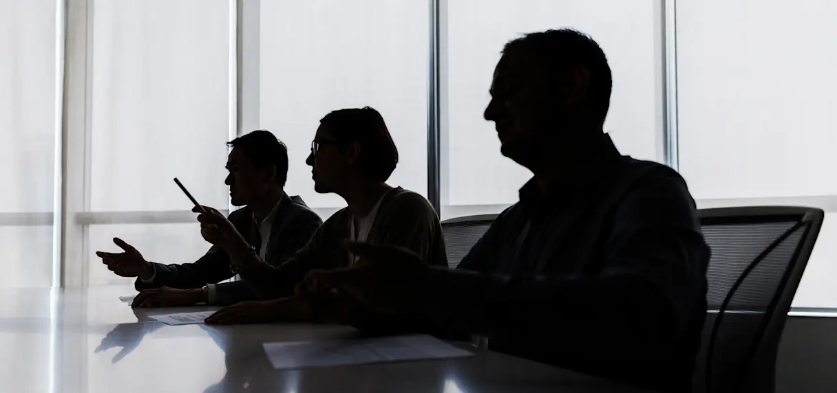 Silhouette of business people negotiating at meeting table