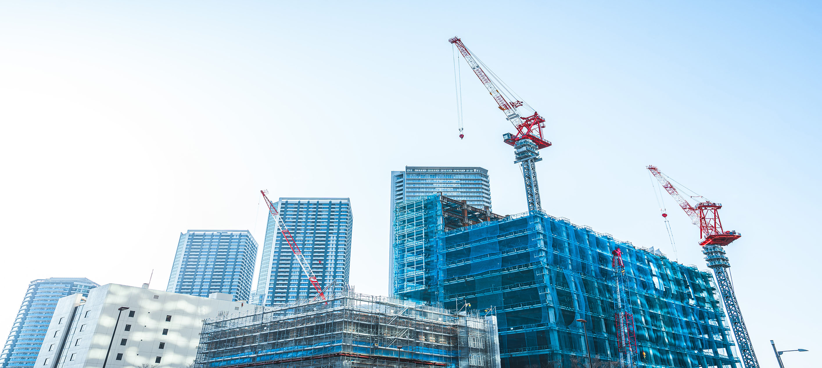 Top view of multiple buildings and cranes