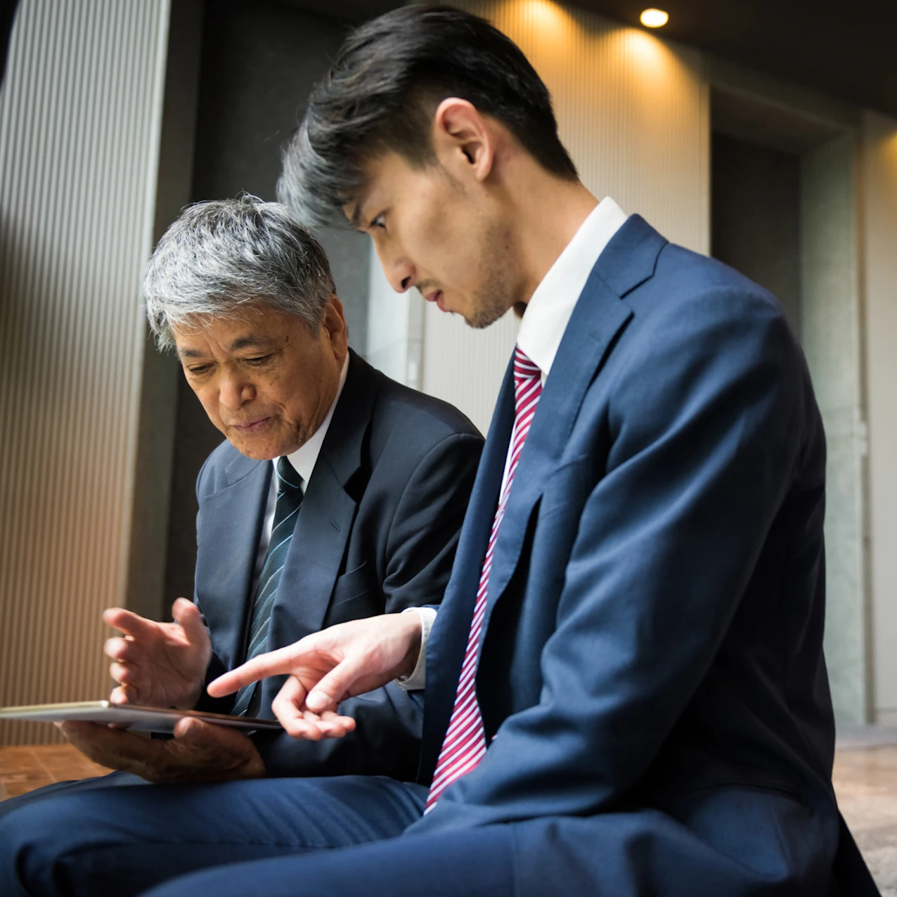 Senior executive and businesman having a meeting in an office building