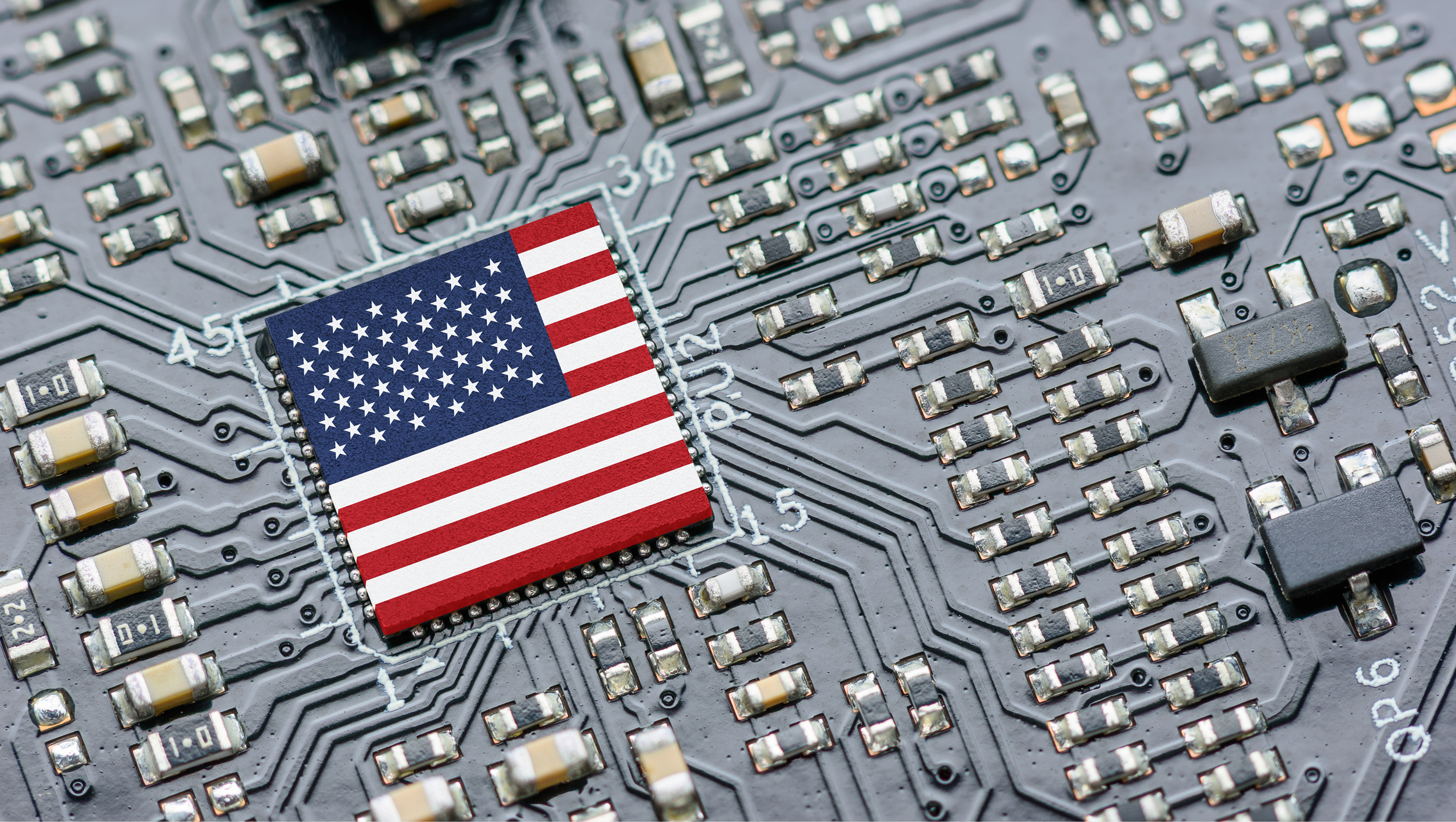 Close-up of a computer circuit board with an integrated chip featuring the United States flag design.
