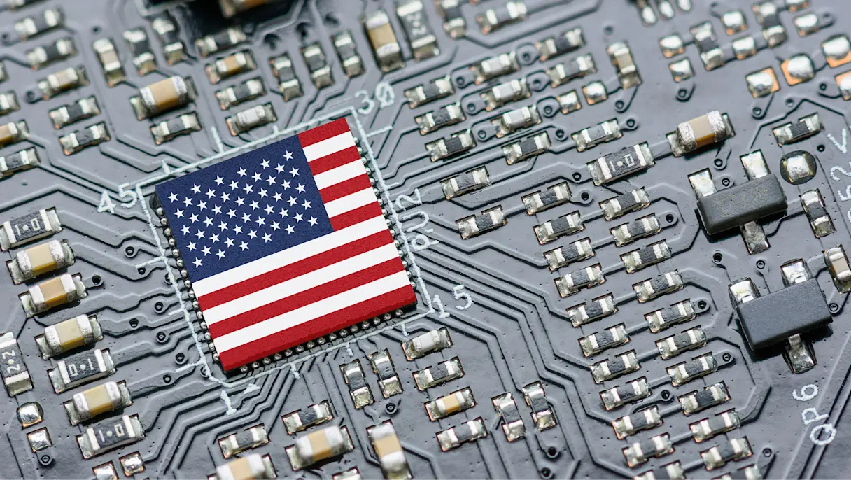 Close-up of a computer circuit board with an integrated chip featuring the United States flag design.