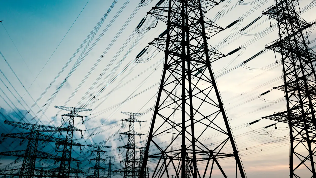 High-voltage power transmission towers at dusk