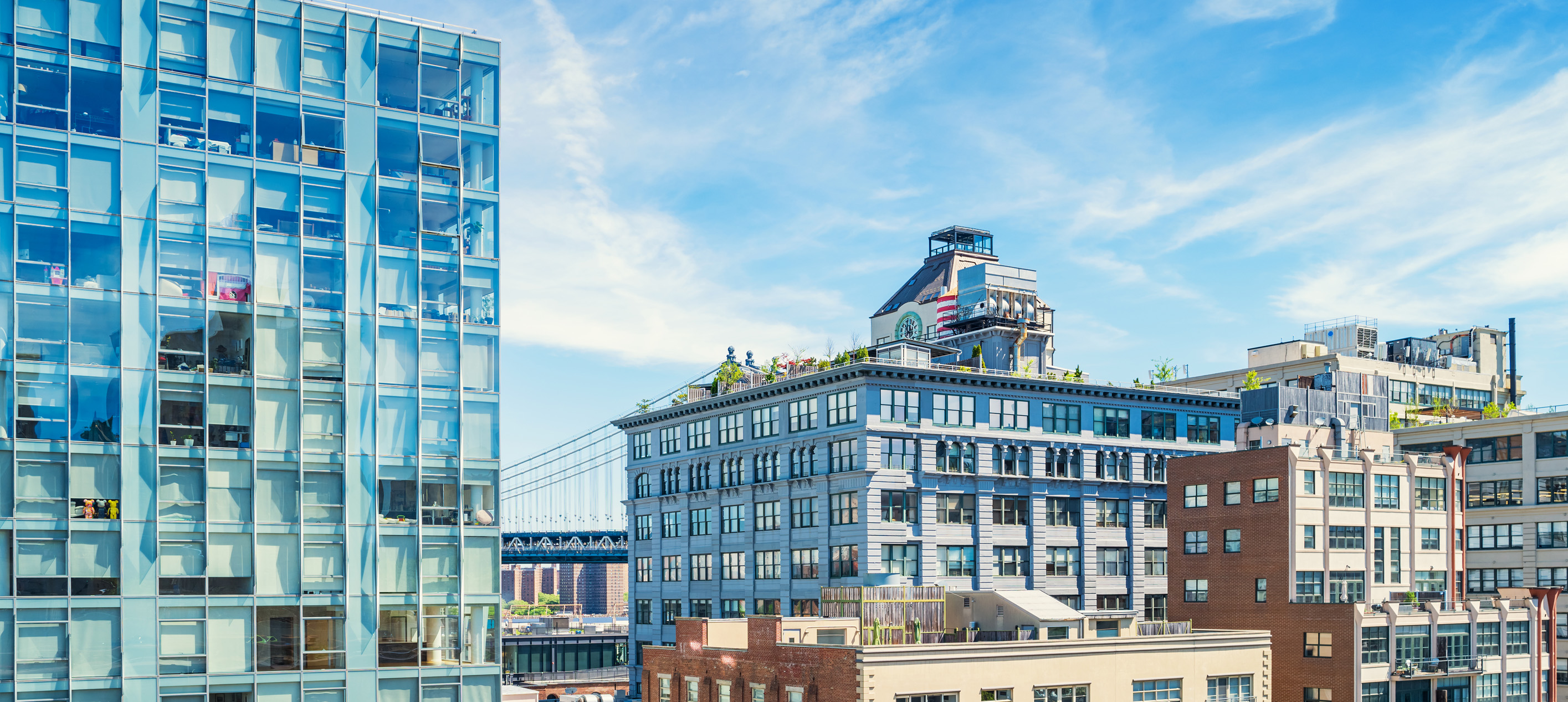 residential and commercial buildings in the Dumbo district of Brooklyn, New York, with the Manhattan Bridge in the background