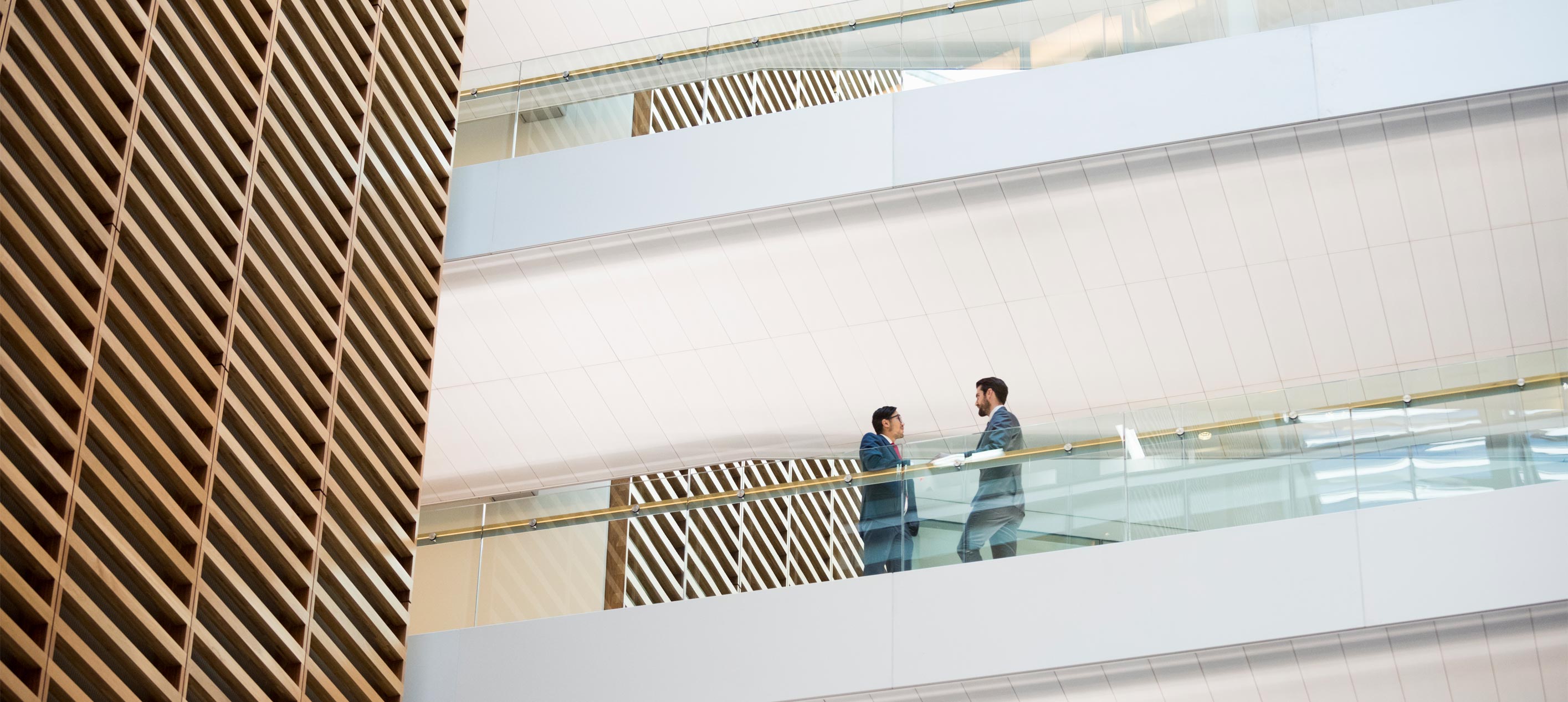 Two professionals having a conversation in an office setting