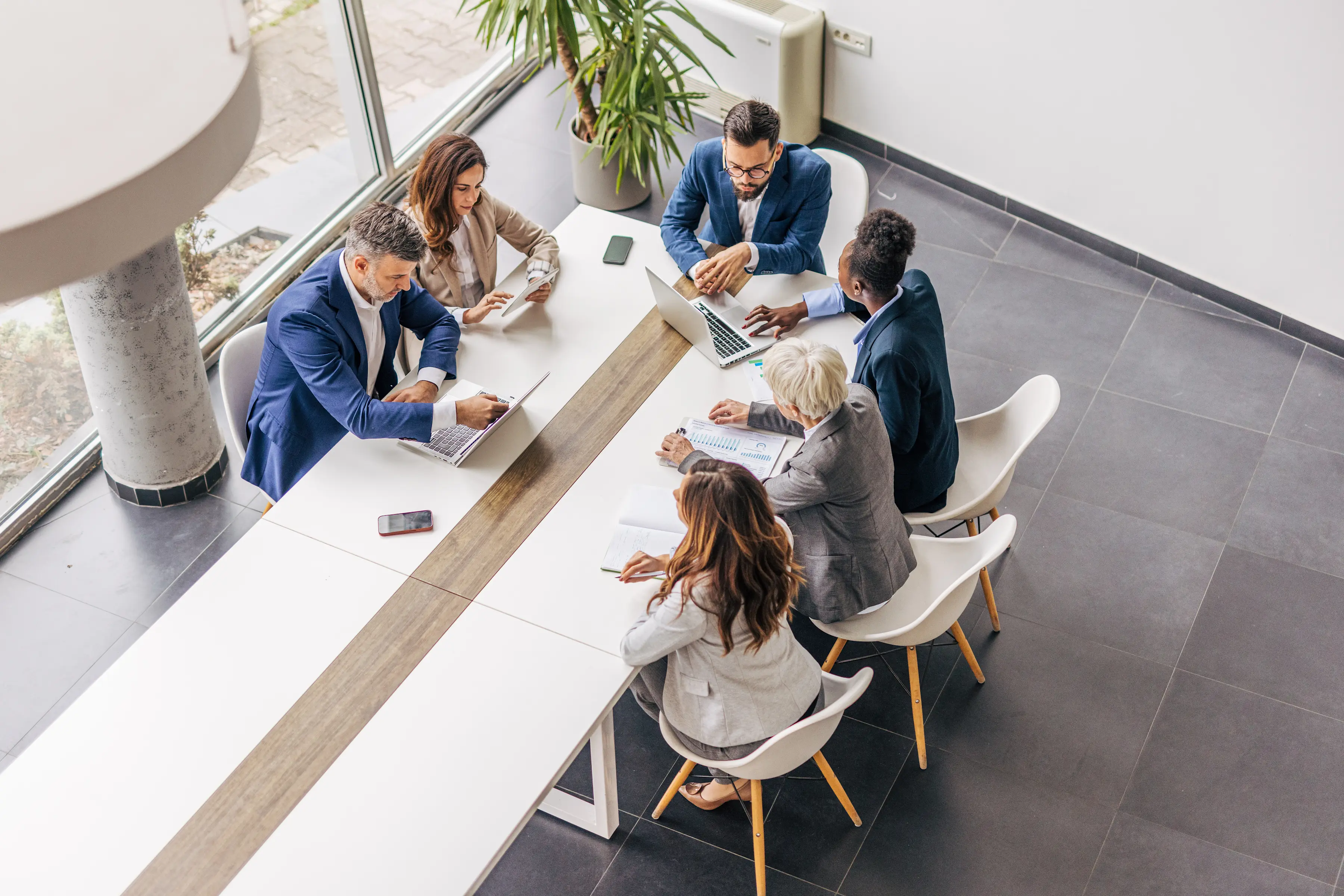 View from above of a conference table with professionals sitting and talking