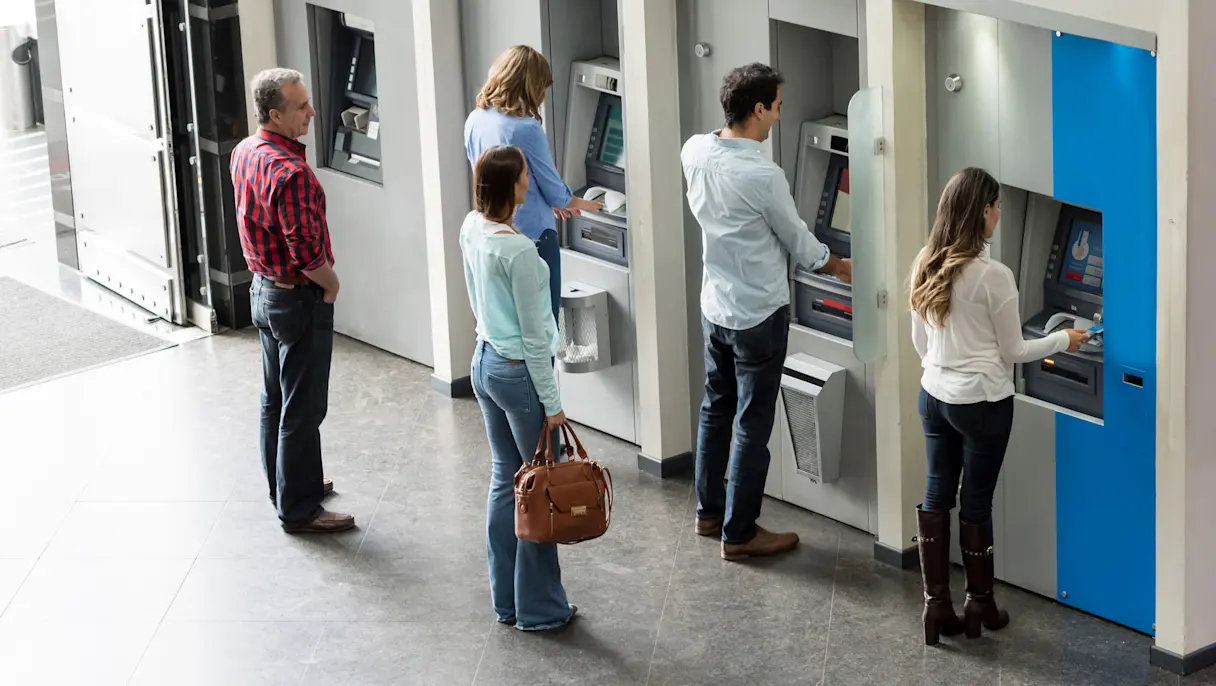 Customers standing in line for the ATM