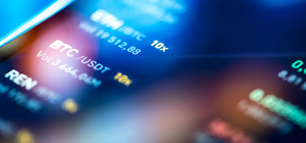 Close-up of a digital cryptocurrency trading screen displaying BTC/USDT pair, volume 3,664.94M, with blue and yellow text on a dark blurred background.