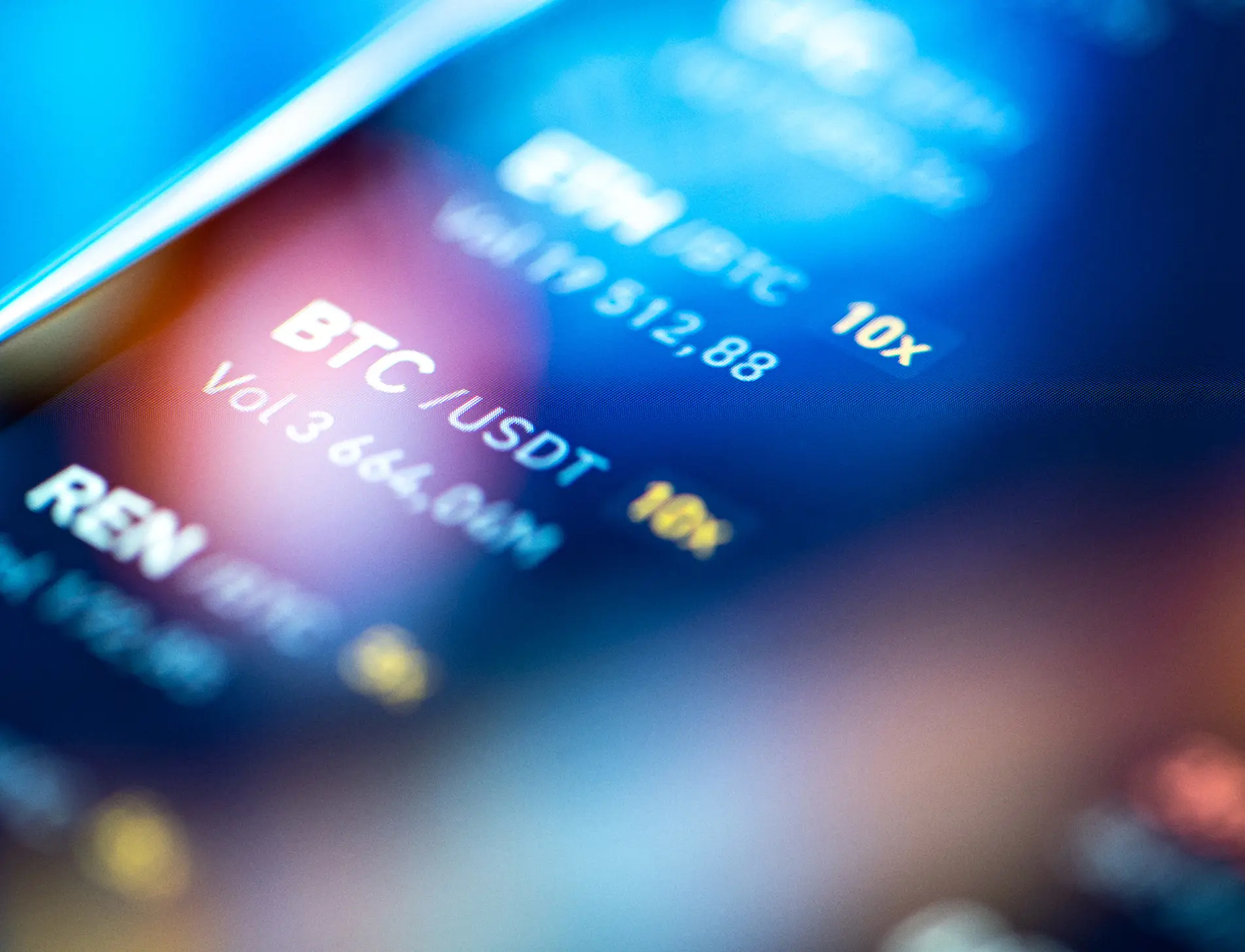 Close-up of a digital cryptocurrency trading screen displaying BTC/USDT pair, volume 3,664.94M, with blue and yellow text on a dark blurred background.