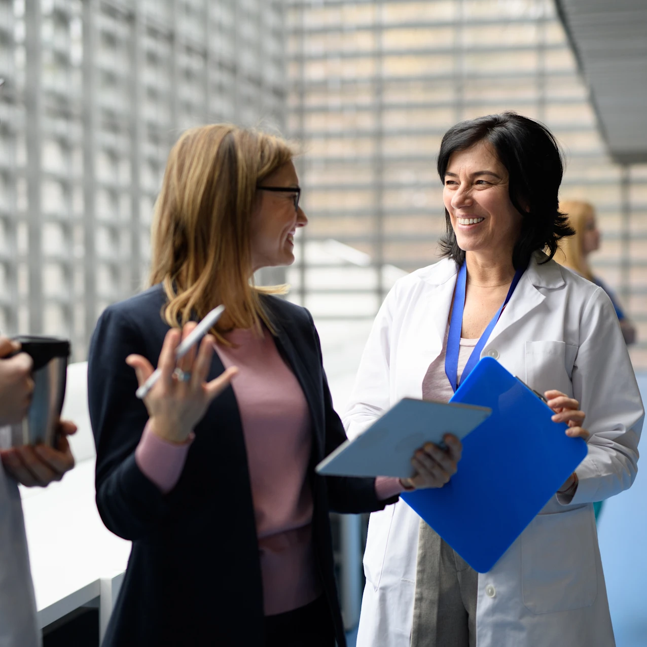 Doctors talking to pharmaceutical sales representative, presenting new pharmaceutical product. Hospital director, manager talking with doctors team.