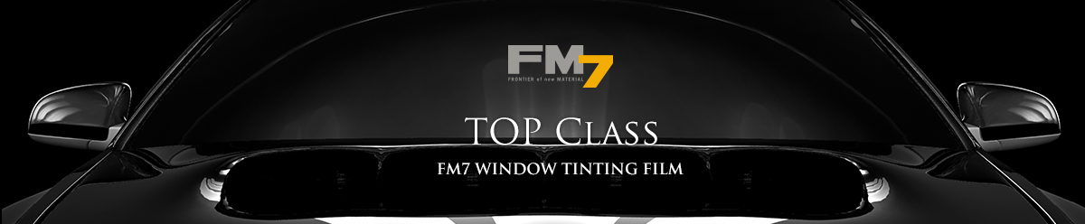 Close-up of a sleek black car hood with “TOP CLASS” and “EM7 WINDOW TINTING FILM” text