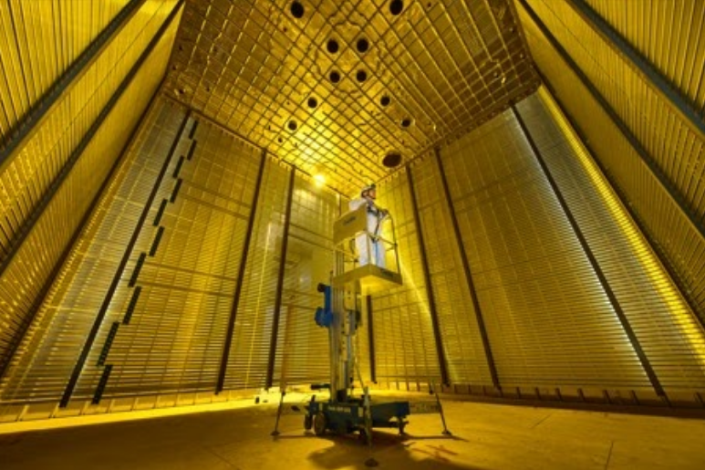Person stands on lift inside of protoDUNE experimental program, which is designed to test and validate the technologies and design that will be applied to the construction of the DUNE Far Detector at the Sanford Underground Research Facility. Credit: CERN