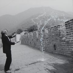 Photo of the Artist throwing a Bucket of Water at the Great Wall of China.