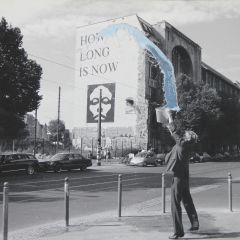 A Photo of the Artist throwing a Bucket of Water in front of Tacheles in Berlin