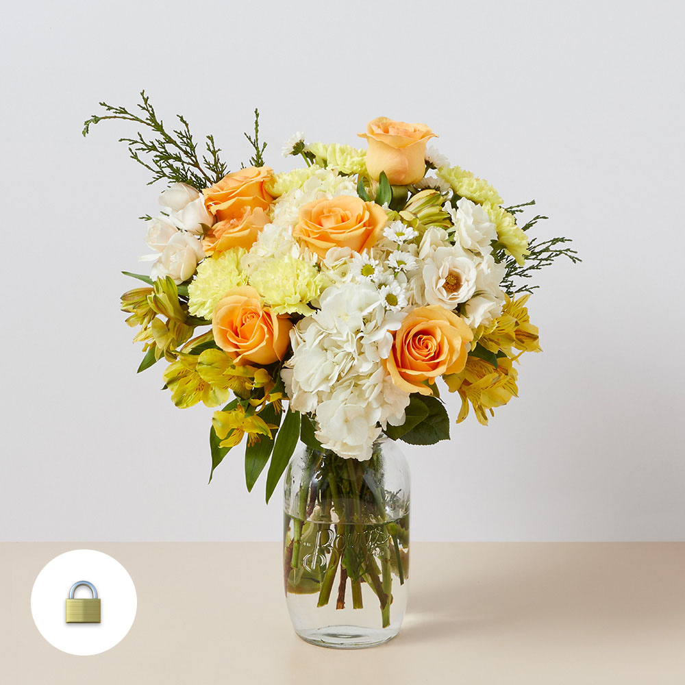 Bouquet of yellow, white and peach flowers including roses and hydrangea