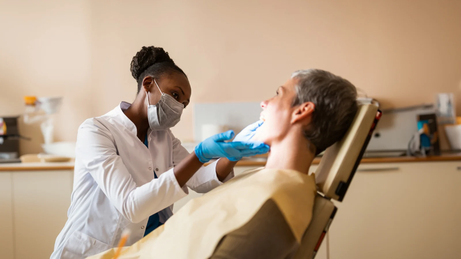 Helps save money, and potentially lives - Dentist checking a patient's mouth