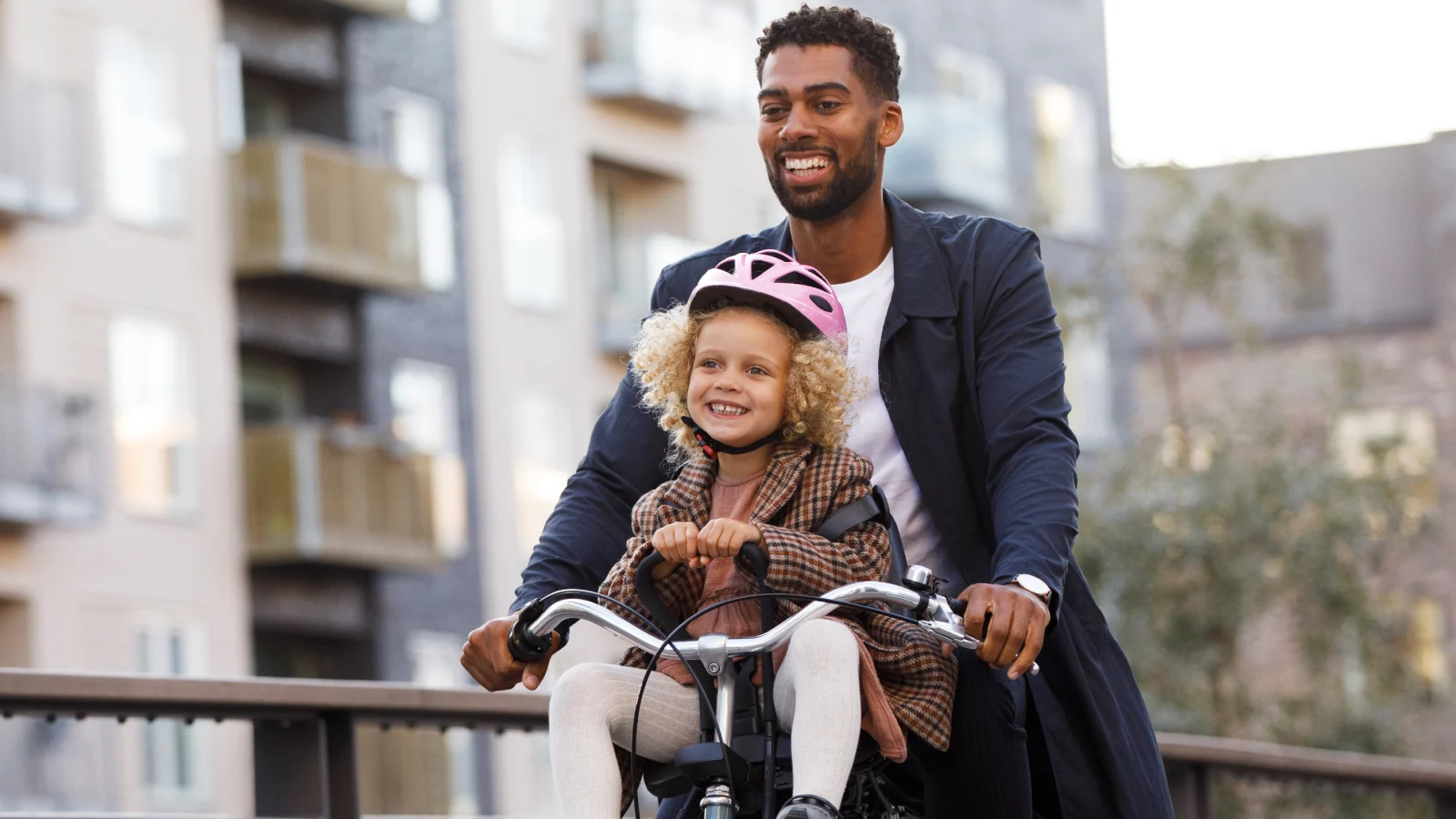 Father and daughter riding on a cycle
