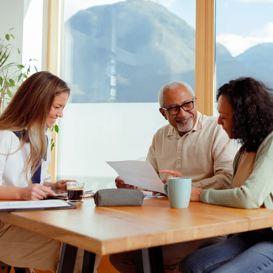 Couple looking over finances with financial advisor