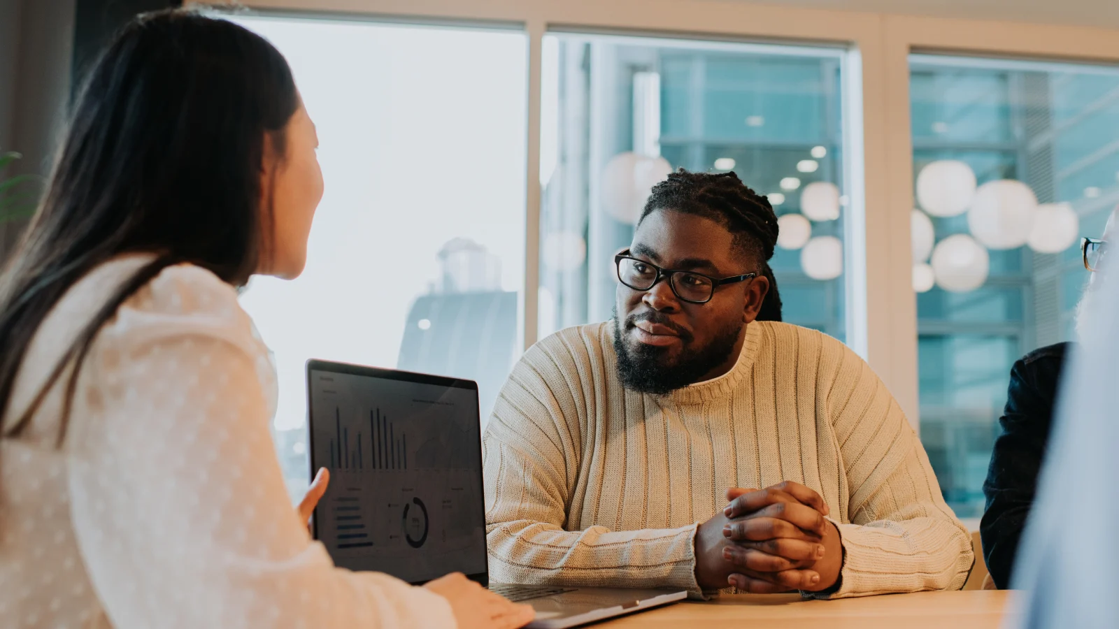 Colleagues talking together in an office.