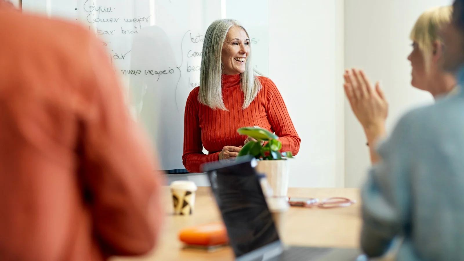 woman standing near the whiteboard smiling