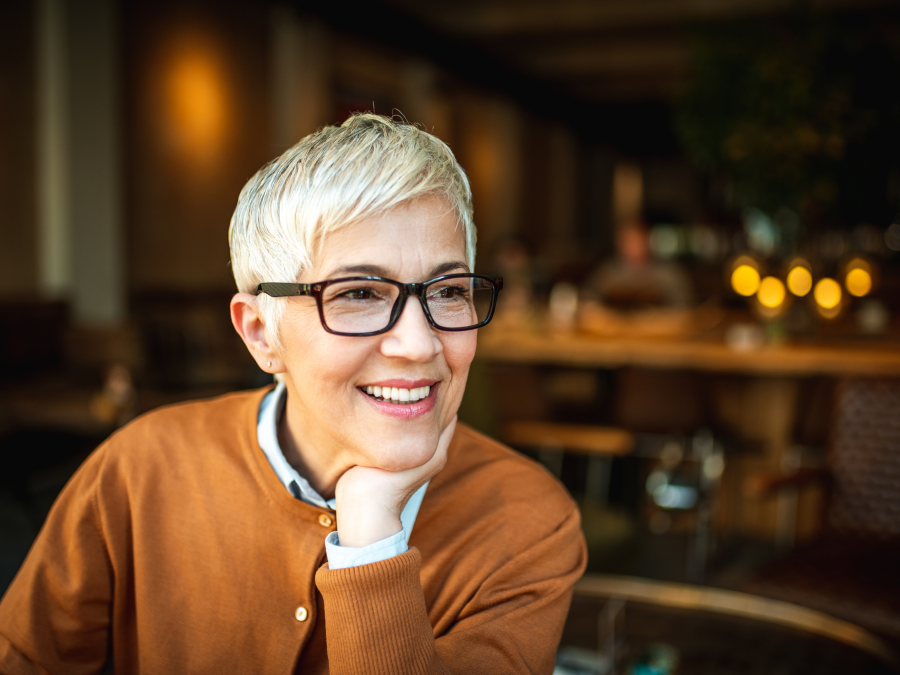 Gray haired woman with heavy glasses