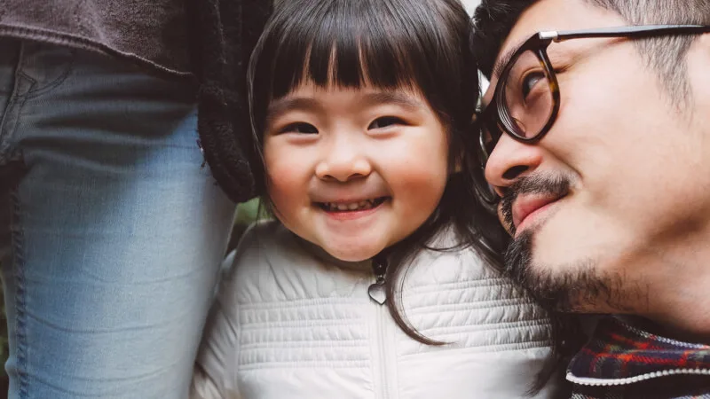 An individual or family plan - Smiling child with parents