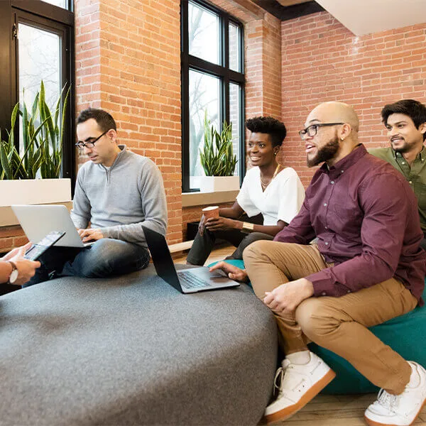 Employees having an informal meeting in an open space at work.