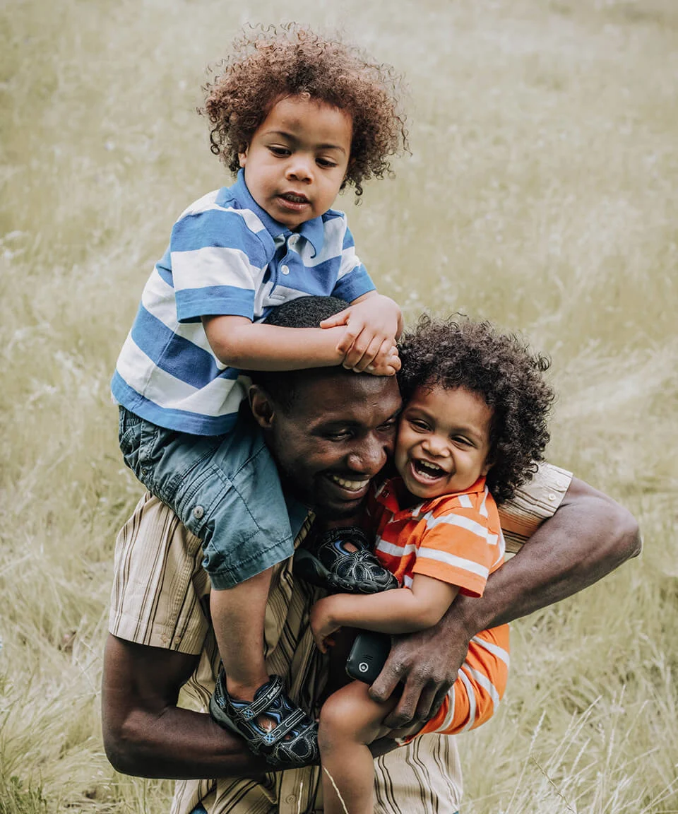 Father holding sons