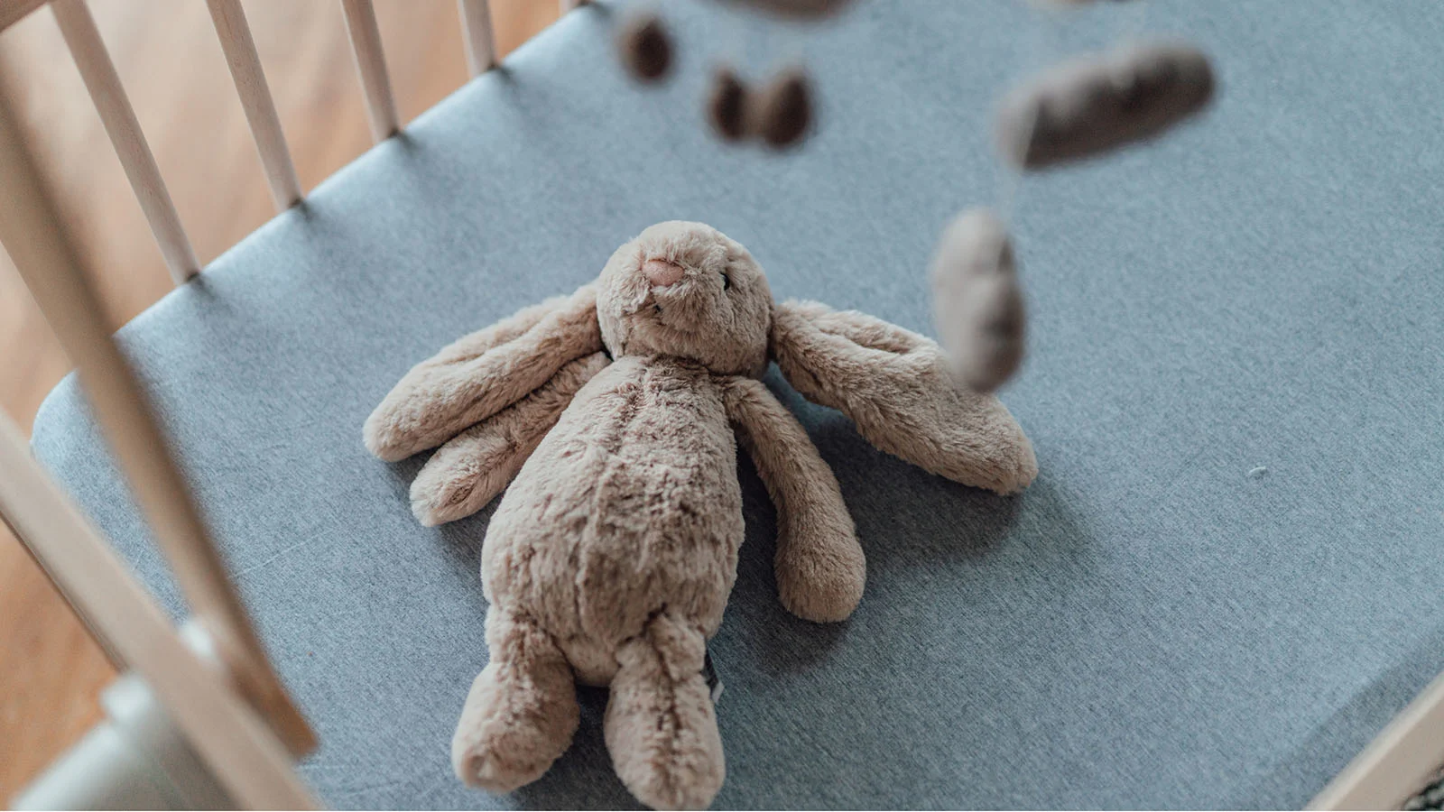 stuffed rabbit toy in a crib