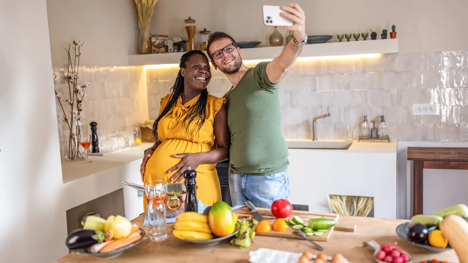 Happy pregnant couple in the kitchen