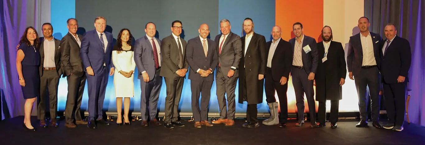 Left to right: Leyla Lesina, Nick Saleem, Marty Nachemson, Mark Murphy, Michele Lee Fine, Ken Alter, Asghar Kazim, Joe Biondolillo, CEO Andrew McMahon, Elie Engel, Matt Liscomb, Jonathan Rosenbaum, Wolf Perl, Vladimir Sasic, Paul Vecchione 